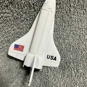 1:370 scale replica of the NASA Space Shuttle orbiter. Metal and plastic.